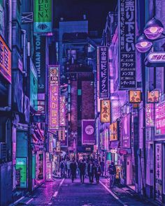 people are walking down an alley way in the city at night with neon signs all around