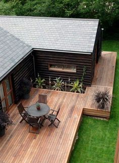 an aerial view of a wooden deck with table and chairs