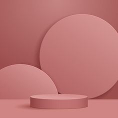 two round objects are shown on a pink background, with one object in the foreground