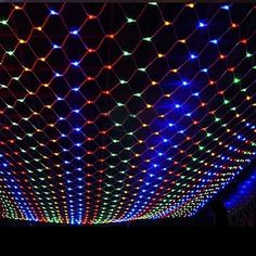 the ceiling is covered with colorful lights and netting covering it's entire area,