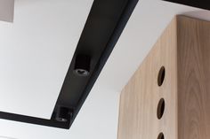 an overhead view of a room with wood and white walls, black metal fixtures and wooden cabinets