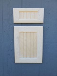 two unfinished wooden frames on a blue wall