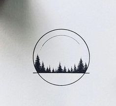 a circle with trees in it on top of a paper