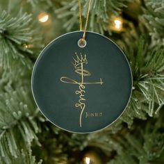 a christmas ornament hanging on a tree with the word, christ in gold lettering