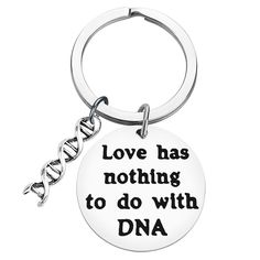 a keychain with the words love has nothing to do with dna on it