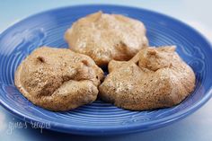 three cookies on a blue plate sitting on a table