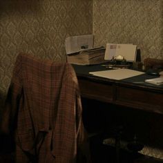 an old fashioned desk with a laptop computer on it and papers scattered about the desk