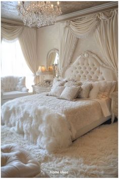 a bedroom with white fur on the bed and chandelier