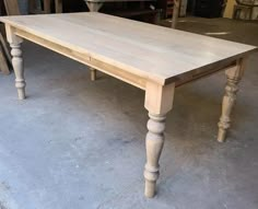 an old table is being worked on in a shop