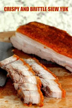 sliced pork sitting on top of a wooden cutting board