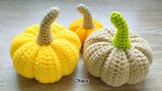 two crocheted pumpkins sitting next to each other