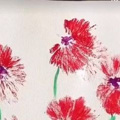 red flowers painted on white paper with green stems