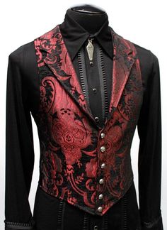 "A Victorian gentleman's vest with class. Great for formal occasions, can be worn under a suit jacket or by itself. Made in red and black tapestry fabric with black satin lining and back. This vest has a very flattering tapered fit and ties in back with satin beltings it can be made tighter in the waist. Fastens in front with six brass buttons. A notched collar adds extra style. Comes in sizes small-3X. (pictured with the empire tux shirt - sold separately) fabulous! Size small = chest 39\" wais Aristocrat Vest, Red Vest Outfit, Royal Costumes, Gothic Fashion Men, Gothic Suit, Tapestry Fashion, Vest Outfits Men, Black And Red Suit, Wedding Vest