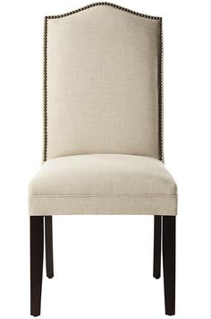 a beige upholstered chair with black trimmings on the back and legs