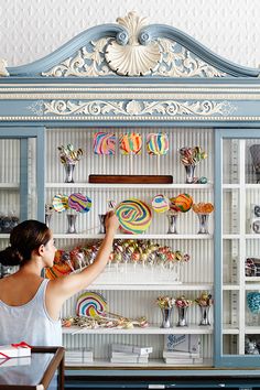 a woman is looking at some candy on display