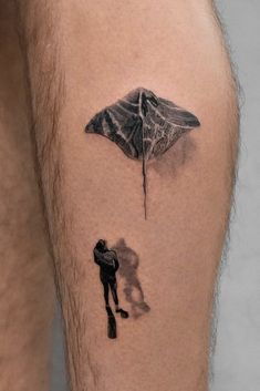 a man with a kite tattoo on his leg