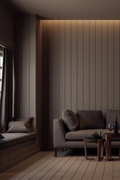 a living room filled with furniture next to a wooden floor covered in wood planks