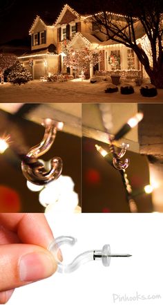 a hand holding a pair of ear buds in front of a house with christmas lights