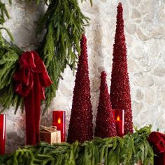 red candles and christmas decorations on a mantle