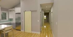 an empty kitchen and dining room with hardwood floors in the foreground, white cabinets on either side