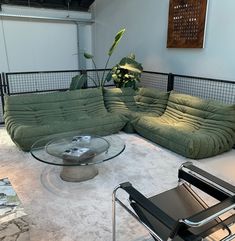 a living room filled with lots of green furniture