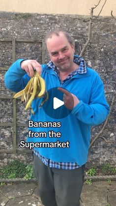 a man holding a banana in his right hand and pointing to it with the words bananas from the supermarket