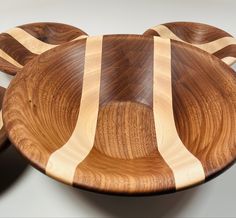 a wooden bowl with white stripes on it