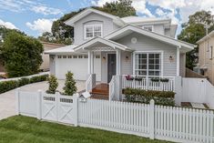 a house with a white picket fence in front of it