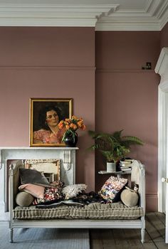 a living room filled with furniture and a painting on the wall