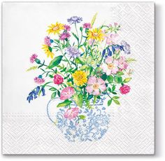 a bouquet of colorful flowers in a blue vase on a white napkin with floral designs