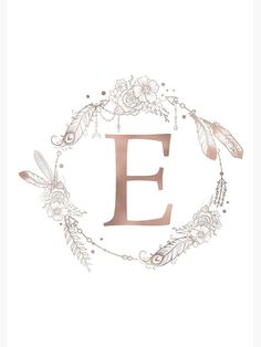 the letter f is surrounded by flowers and feathers in a circle with an e on it