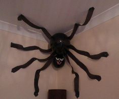 a large spider mounted to the ceiling in a room