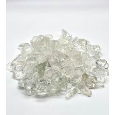 some very pretty clear glass pieces on a white surface with no one around them or in the background