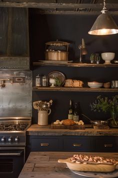 a kitchen with an oven, stove and counter top in front of shelves filled with food