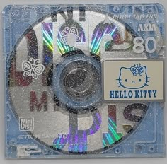 a hello kitty cd is shown on a clear plastic case with blue and silver trim