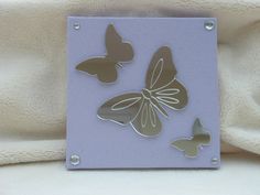 a glass plaque with three butterflies on it