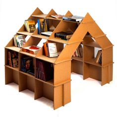 a book shelf made out of cardboard with books on it and an open roof section