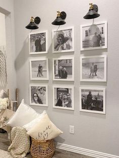 a room with pictures on the wall and pillows