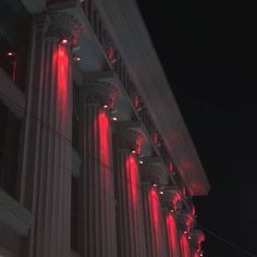 red lights are lit up on the side of a building