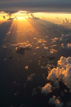 the sun is shining through clouds above the water in this aerial photo taken from an airplane