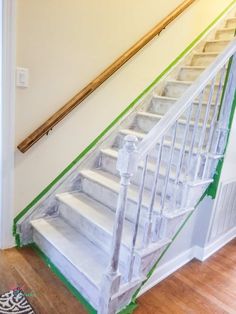 a white stair case with green tape on it