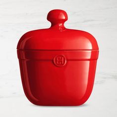 a red container sitting on top of a white counter