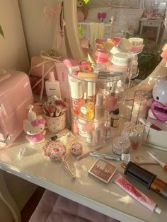 a vanity with cosmetics and other items on it