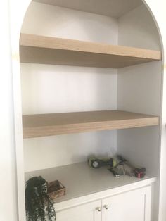 an empty shelf in the corner of a room