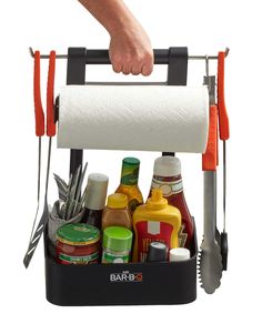 a person holding a roll of toilet paper in front of a rack full of condiments