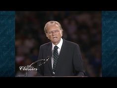 a man in a suit and tie giving a speech