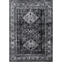 an area rug with black and white designs on the front, dark gray background in the middle