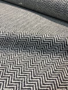 a close up view of a black and white herringy fabric with an interesting zigzag pattern