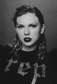 a black and white photo of a woman with dark lipstick