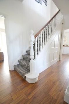 an image of a house with stairs and wood flooring on the bottom right hand side